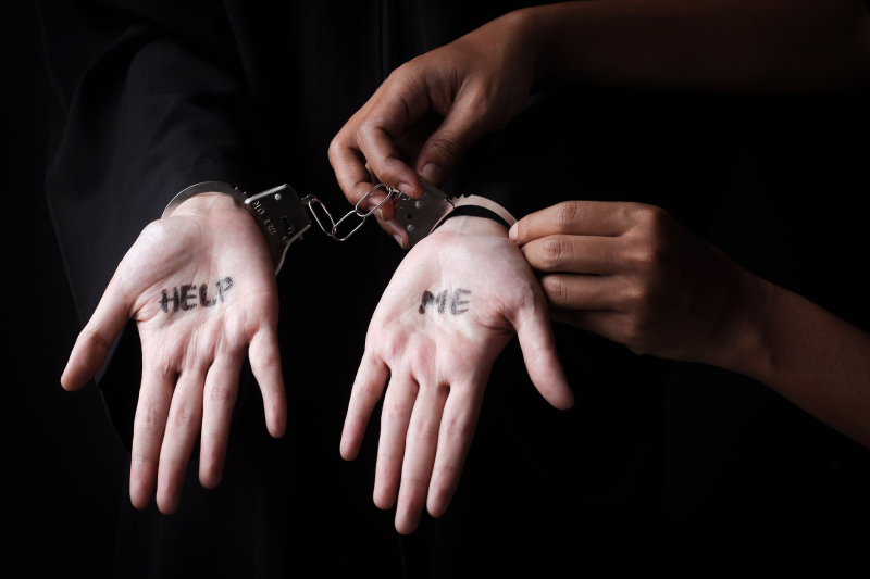 Text HELP Written On Woman Palm While Handcuffed